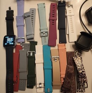 Fitbit Versa and several large and small bands